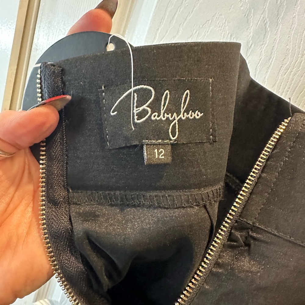 Baby boo sateen feeling , but not satin.High waisted, a zipper
